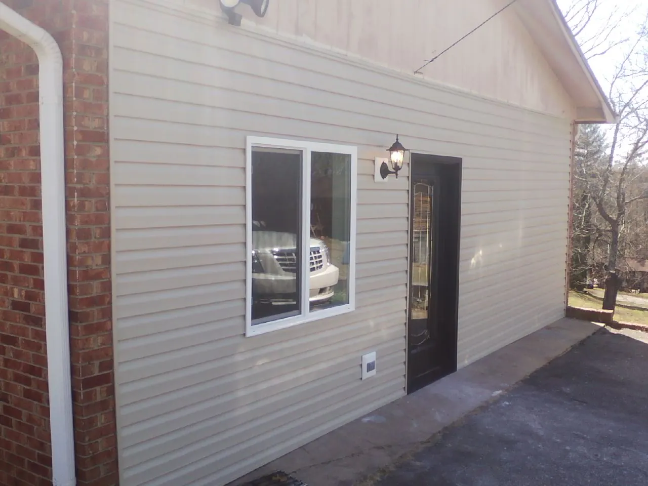 New vinyl siding and entry door on a room addition in Bradley